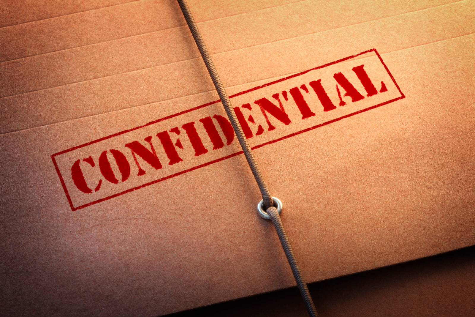 A close up of "Confidential" stamped on a file folder.